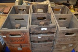 Three vintage wooden bottle crates and demi johns
