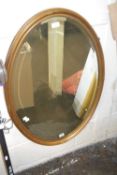 An oval bevelled wall mirror