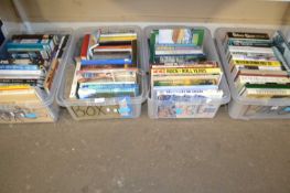 Four plastic boxes of mixed books