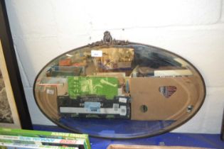 Oval bevelled wall mirror in metal frame