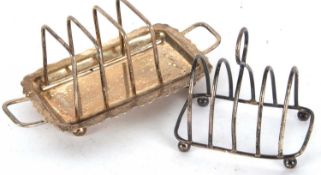 An Edwardian small silver toast rack of lancet shape with four divisions and central loop carry
