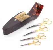 An early 20th Century tortoiseshell scissor case containing four pairs of graduated scissors, the