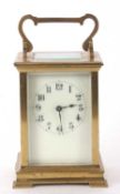 A four glass carriage clock with enamel dial and black Arabic numeral hour markers, it has a key