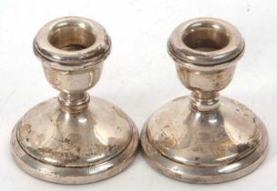 A pair of Elizabeth II silver dressing table candlesticks, 6.5cm tall, Birmingham 1976, makers