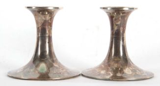 A pair of Edwardian silver dressing table candlesticks of plain polished design, Birmingham 1906,