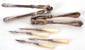 A cased set two pairs of silver plated nut crackers together with four mother of pearl hand tools