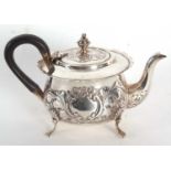 A late Victorian silver bachelors teapot having a card cut rim, ebonised handle, the hinge lid