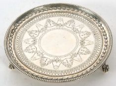 A Victorian silver card salver having beaded rim around a border of wheat husks, chased and engraved