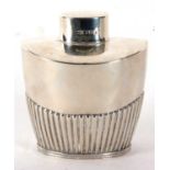 An Edwardian silver caddy of tapering oval form, part fluted body with pull off lid, hallmarked