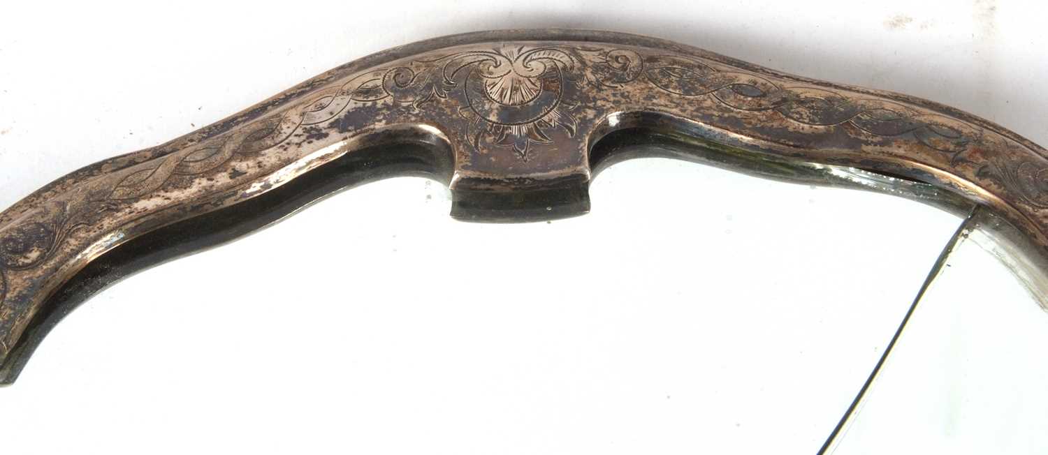 A continental dressing table mirror of escutcheon form, the metal frame engraved with a Celtic - Image 3 of 5