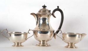 A three piece George V tea service of plain baluster form with beaded edges, the coffee pot