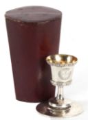A cased Victorian silver two part travelling communion set comprising goblet and paten, both with