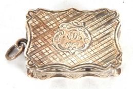 A Victorian silver vinaigrette of rectangular form having wavy edges, chased and engraved all over