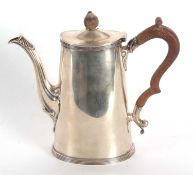 A George V silver small coffee pot of plain oval form with reeded edges standing on a collet foot