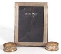 Mixed Lot: A silver photograph frame of rectangular form with reeded and bow border having easel