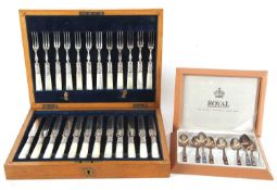 An antique oak cased set of twelve pairs of mother of pearl handled dessert eaters, together with