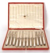 A cased set of six pairs of silver handled dessert eaters, hallmarked for Sheffield 1915, makers