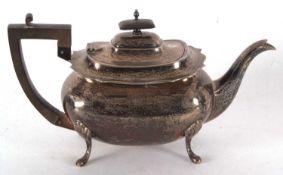A George V silver teapot of plain rectangular form having a wavy edge, ebonised handle and finial,