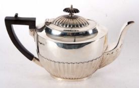 A George V silver teapot, part fluted decoration to hinged lid and body, ebonised finial and handle,