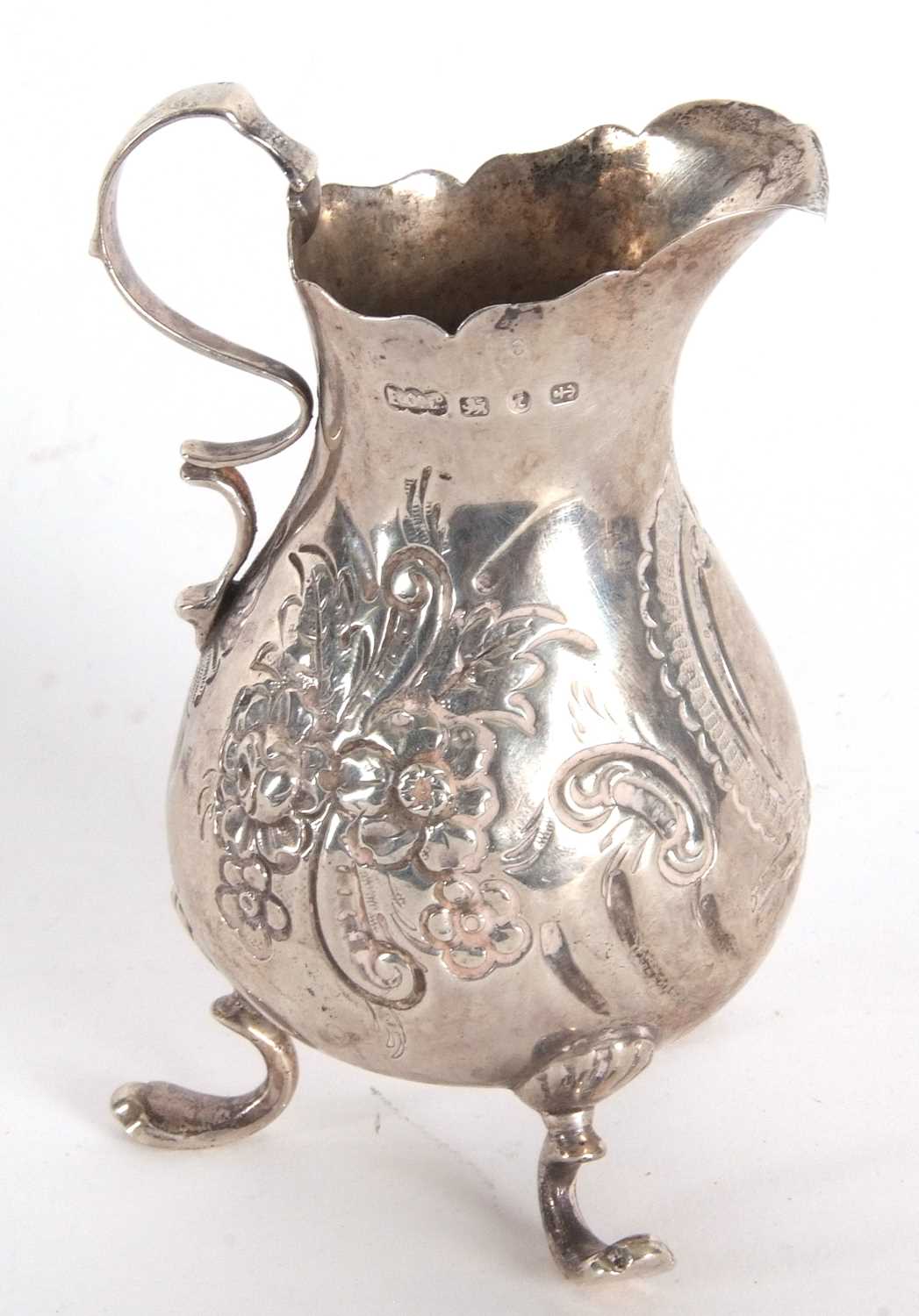 A late Victorian silver cream jug having a round bellied body with chased and embossed floral - Image 4 of 4