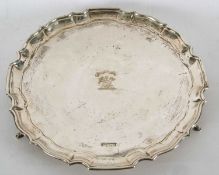A George V silver salver having a pie crust border, the centre engraved with a sheath of arrows