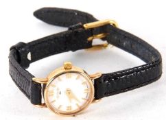 A 9ct gold W H Willman ladies wristwatch, the watch has a quartz movement, a white dial with gold