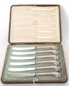 A cased set of six Edwardian silver pistol grip knives, handles hallmarked for Sheffield 1910,