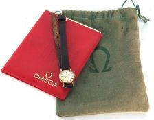 A 9ct gold ladies Omega wristwatch, stamped 375 inside the case back, the paperwork and pouch are