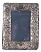 An Elizabeth II silver mounted photograph frame of rectangular form embossed with leaves and scrolls
