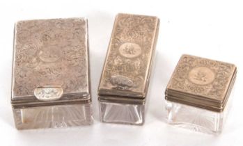 Three Victorian glass and silver mounted gents dressing table jars, two rectangular shape with screw