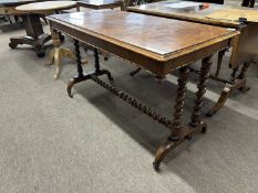 A Victorian walnut veneered centre table with rectangular top over a barley twist frame with brass