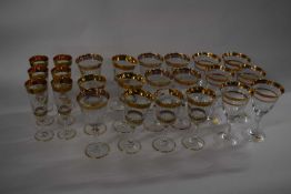A group of crystal Murano wine glasses and champagne flutes etc, all with gold leaf rims, four