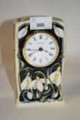 A modern Moorcroft clock case with applied floral decoration, the base signed by Rachel Bishop, 16cm