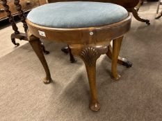 Early 20th Century oval walnut veneered stool with cabriole legs and shell carved detail, 56cm wide