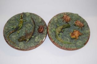 A small pair of Portuguese Caldas pottery palissy style plates decorated in relief with dragons,