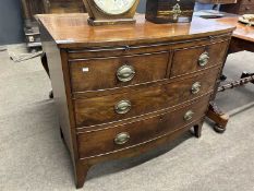 A late Georgian mahogany bow front chest with brushing slide over two short and two long drawers