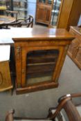 Victorian walnut veneered and floral inlaid pier cabinet with single arched glazed door opening to a