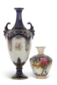 A Royal Worcester vase with mask handles painted with panels of fruit and flowers together with a
