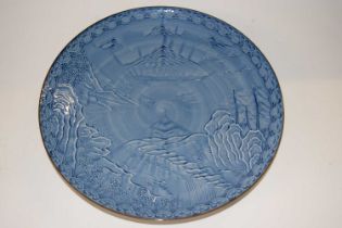 A Japanese porcelain dish with a blue and white landscape design, 31cm diameter