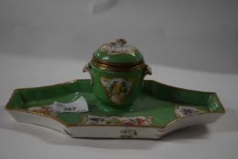 A porcelain ink well on shaped base, the green ground decorated with panels of floral sprays, the