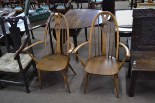 A pair of Ercol swan back carver chairs