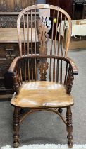 A 19th Century yew and elm seated Windsor type chair with turned legs and crinoline stretcher