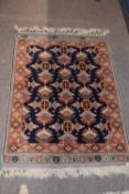 Small Middle Eastern Wool floor rug with central blue panel with geometric motifs, 117 x 69cm