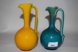 Two Linthorpe pottery glazed ewers, shape number 826 after Christopher Dresser Designs, 18cm high (