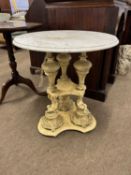 An unusual circular marble topped occasional table on triple pedestal, cast metal (probably
