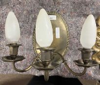 A pair of 20th Century brass three branch wall lights with oval panelled backs, 24cm high