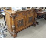 Late Victorian oak sideboard with two drawers and two panelled doors with carved decoration, 150cm