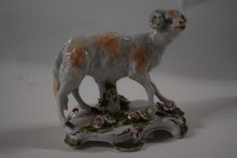 An English porcelain model of a ram on shaped base applied with flowers, possibly Bow or Derby, 10cm