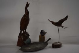 Collection of bird sculptures including two carved wooden models of birds, further resin model of
