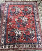 An Afshar wool rug decorated with geometric patterns in red, blue and cream, 201 x 151cm (Item 66 on